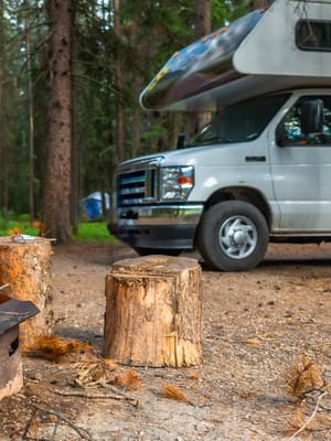 campfire-burning-brightly-next-to-rv-in-campsite